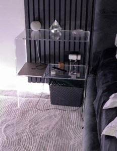 Bent bedside table with additional shelf
